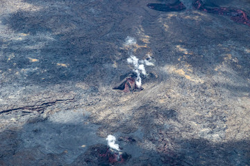 Active fissures in Leilani Estates on Hawaii's Big island. Surrounded by recent lava flow, red...