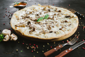 Vegetarian mushroom pizza on black background