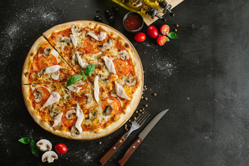 Tasty pizza with chicken meat on black background