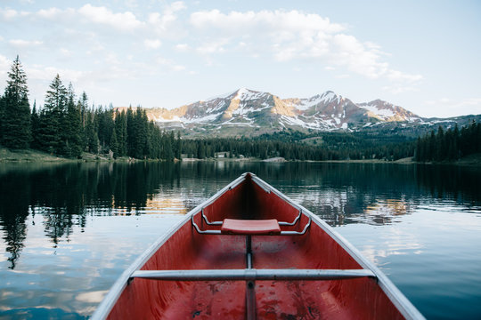 An empty boat on the way with mountains and trees in the background
