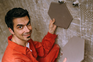 Repairer holding tiles