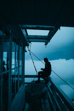 Person sitting outside on a ledge
