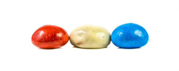 Pepernoten bunch of colored cookies in dutch flag colors on white background
