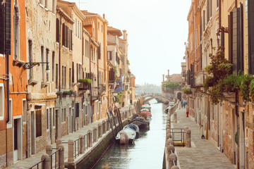 Fototapeta na wymiar Venice, beautiful romantic italian city on sea with great canal and gondolas. View of venetian narrow canal. Venice is a popular tourist destination of Europe.