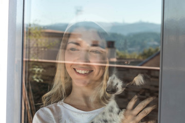 young girl at home next to the window at christmas