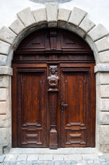 Fototapeta na wymiar Old mahogany door with decorative carvings.