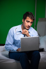 Young businessman under stress in the bedroom at night