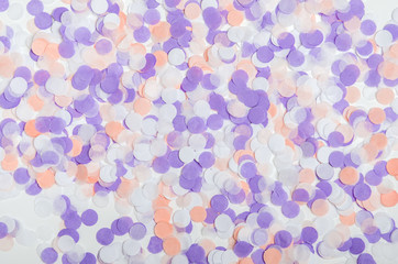 Multicolored confetti of pastel pink, lilac colors. Festive confetti for birthday, new year. Background, top view, flat lay