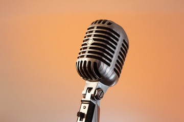 Retro microphone against light restaurant background on stage