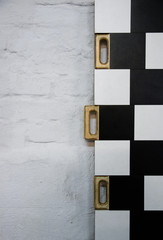 half black and white random checkered texture wooden handles to move the boards to the sides of the background