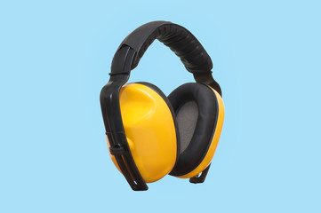 Earmuffs of safety gear and workwear on blue background construction