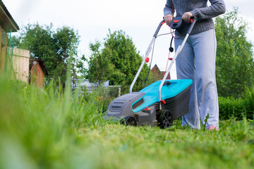 outdoor worker mowing the lawn