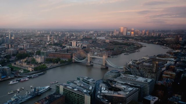 time lapse London skyline with illuminated Tower bridge and Canary Wharf in sunset time, UK