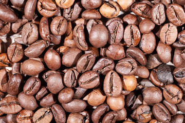 A handful of roasted coffee beans close-up