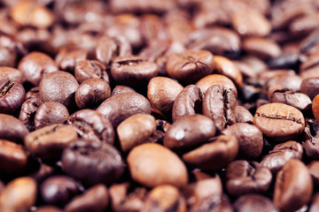 A handful of roasted coffee beans close-up