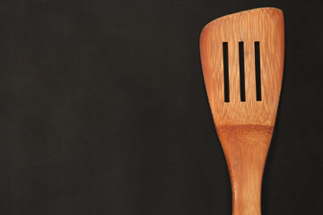 cooking spatula on black background