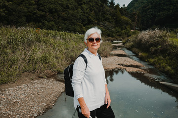 .Lovely middle aged woman enjoying a morning sightseeing outside of Kyoto in Japan. Tourist trip...