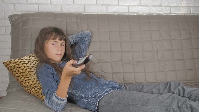 A child with a remote control from the TV.