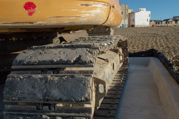 Yellow excavator and tracks