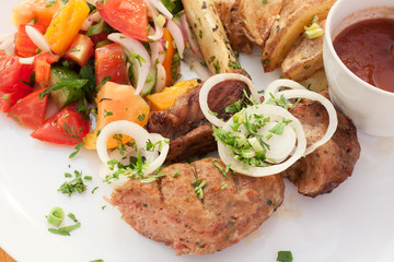  barbecue meat dishes potatoes vegetables and sauce 
