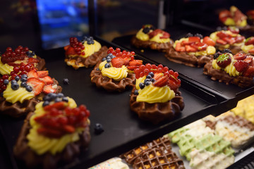Belgian waffles with chocolate, berries, sweet sauce, cream