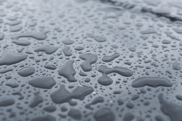 Natural water drops on a glass table after rain.