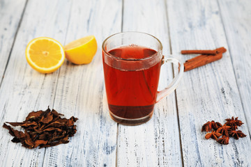 hot tea, cinnamon sticks, star anise, dried tea leaves and orange