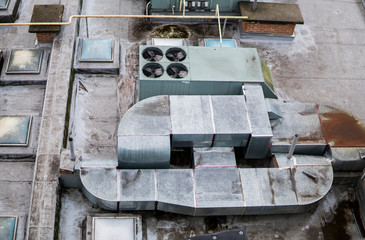 Dirty old roof of a multistory. Ventilation systems on building roof.