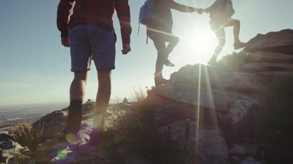Group of people enjoying being on mountain peak - Powered by Adobe