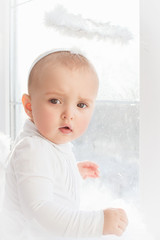Smiling baby with angel wings and a halo