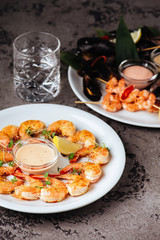 Mussels and shrimps on stone table.