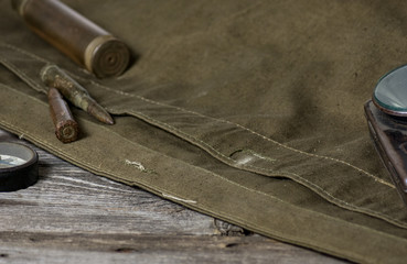 7,92 x 57 - rustic ammos, poncho and old flashlight lies on the wooden background