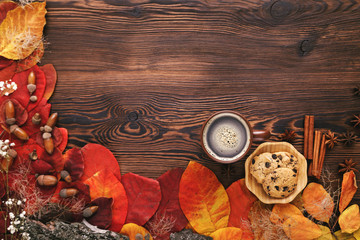 autumn leaves, cookies and tea on wooden background