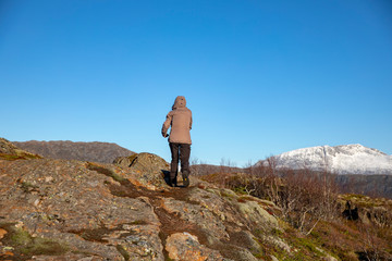Naklejka na ściany i meble Woman walking in mountain tral, Nordland county