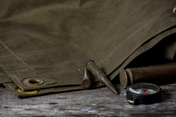 7,92 x 57 - rustic ammos, poncho and old compas lies on the wooden background
