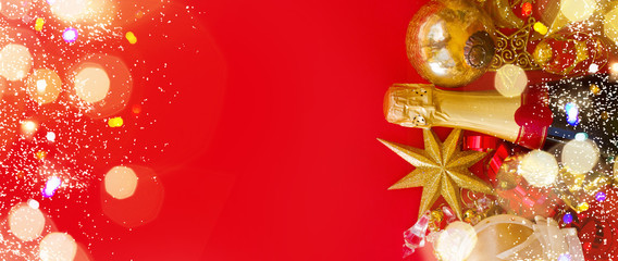 Christmas and New Year decorations with bottle of champagne on red background banner