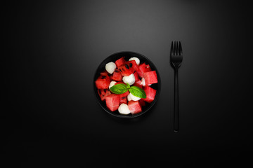 watermelon in black bowl