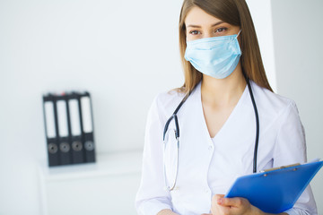 Clinic. Smiling young doctor in hospital corridor