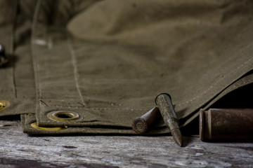 7,92 x 57 - rustic ammos, poncho and old compas lies on the wooden background © Morev_N