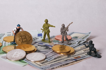 War of money concept. Bitcoin and worker miniatur