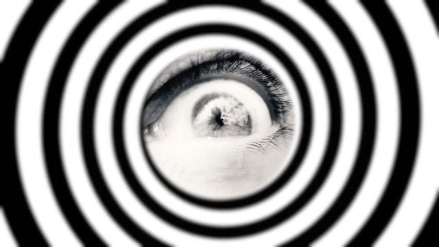 A moving hypnotic spiral, with a scary eye of a man at the center. Halloween horror shot.
