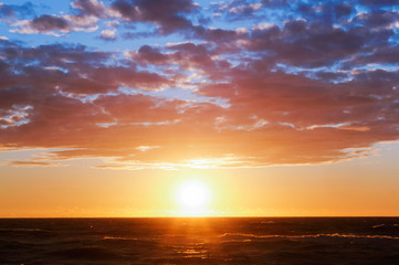 Naklejka na ściany i meble Beautiful sunrise and waves on the sea. Sunset on the Baltic sea.