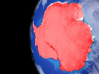 Antarctica from space on model of planet Earth with very detailed planet surface and clouds. Continent highlighted in red.