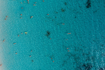 Top down shot of sea surface with swimmers
