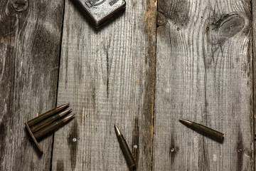 Disassembled clip with cartridges 7,92 x 57 - rustic ammos lies on the wooden background