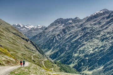 Fototapeta na wymiar Tyrolean alps, mountain hiking, walk along the mountain paths in Oetztal, a couple of people walk along a mountain path