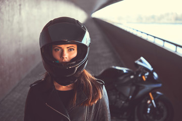 Close-up portrait of a biker girl inside the bridge.