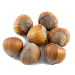 a pile of hazelnuts on white background