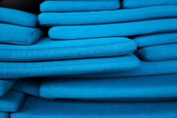 The mountain of blue pillows lie on one another. Pillow texture.