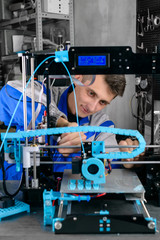 Young designer engineer using a 3D printer in laboratory